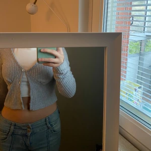 Grå ribbad kofta - Säljer en superfin grå ribbad kofta med knappar framtill. Den är croppad och har långa ärmar, perfekt och passar perfekt till jeans eller kjol. Perfekt för höst och vår! pris kan diskuteras💗