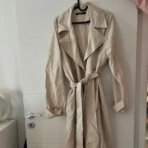 Tunn trenchcoat från Gina tricot. Sparsamt använd. Storlek: L-XL