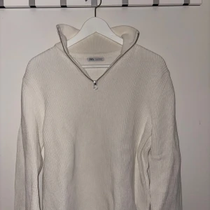 Vit ribbad tröja från Zara - Säljer en stilren vit ribbad tröja från Zara med dragkedja vid halsen. Perfekt för lager-på-lager och passar till många olika stilar. Tröjan har långa ärmar och en bekväm passform. Även den här är typ oanvänd💖 nypris är 499 kr, jag säljer för 200kr. Hör av dig vid frågor🫶🏼
