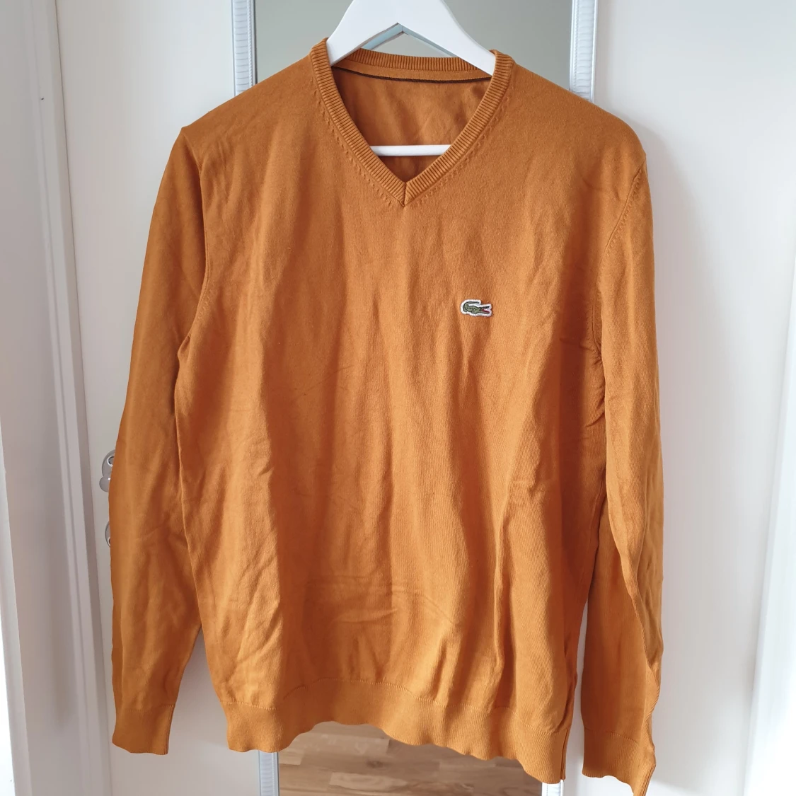 Orange tröja från Lacoste