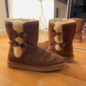 Bruna uggs med rosetter - Bruna uggs från deras märke koolaburra med rosetter och ull!! Såå fina t hösten 🍂🍁För små för min syrra som köpte dom. Som man ser på bild 3 har den högra skon ett litet hål där bak men det är inget som inte kan fixas! ❤️pris kan alltid diskuteras! 