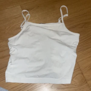 Vit linnetopp - Säljer en enkel och stilren vit linnetopp med smala axelband. Perfekt för varma dagar eller som ett basplagg i garderoben. Toppen är i ett mjukt och bekvämt material.❤️