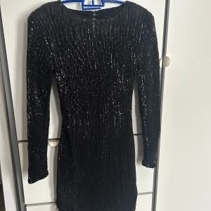 Festklänning med öppen rygg  - Glittrig klänning med öppen rygg 