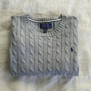 Grå stickad tröja från Polo Ralph Lauren!! - Hej säljer en Polo Ralph Lauren tröja som är en super fin  i 9/10 skick!! Tröjan är i storlek M 10-12 men passar för en XSS. Den är jätte mysig och varm och gör den perfekt för dom kallare månaderna! Supermysig och stilig, skriv för flera frågor! :)