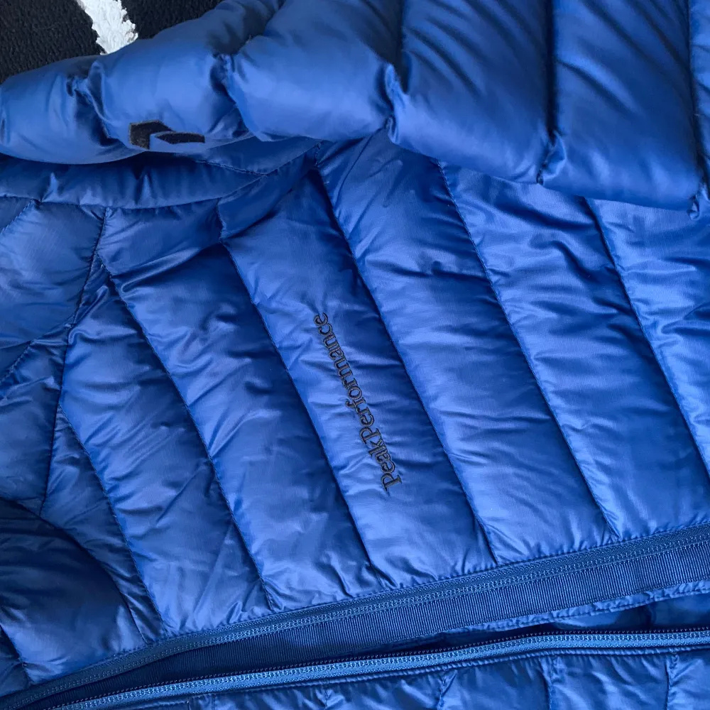 Blå Peak performance jacka i modell M Frost Down Hood jacket. Använt kanske 3 gånger. Ny utan prislapp. Inga defekter.. Jackor.