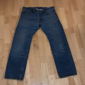 Blå diesel jeans   - Säljer ett par klassiska blå jeans från Diesel med en straight passform. De har en snygg tvätt och traditionella fem fickor. Perfekta för en avslappnad stil.