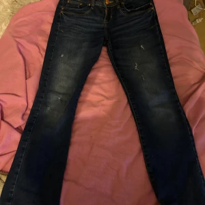 Mörkblå jeans med bootcut - Snygga mörkblå jeans med bootcut-stil. De har en klassisk femficksdesign och är tillverkade i ett slitstarkt denimtyg. Perfekta för en avslappnad look.