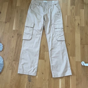 Low waist cargo pants Gina Tricot  - Low waist cargo jeans. Beigea low waist cargo pants från Gina Tricot. Aldrig använda. Nypris 499✨  Köparen står för frakten.