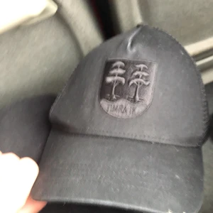 Svart keps med broderad logotyp - Snygg svart keps med en broderad logotyp framtill. Perfekt för en stilren look. Kepsen har en klassisk design och är lätt att matcha med olika outfits.