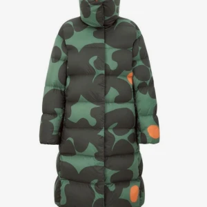 Marimekko Uniqlo dunjacka - Säljer varm och lätt dunjacka från Marimekkos samarbete med Uniqlo i grönt och svart med orange detaljer. Jackan har ett unikt camouflagemönster och är perfekt för kalla vinterdagar. Den är lång och har långa ärmar, vilket gör den extra mysig. Passar i någon mellan XS och S i stl.
