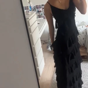 Svart långklänning med volanger - Säljer en svart långklänning! Har använts en gång på studentskiva🙌🏼skriv vid frågor😊