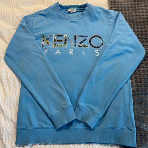 Säljer en snygg blå sweatshirt från Kenzo. Tröjan är i bra skick och perfekt för vardag. Priset är prutat och klart, Möts endast i Sthlm eller skickas vid snabb o smidig affär. Ny pris 1999kr. 