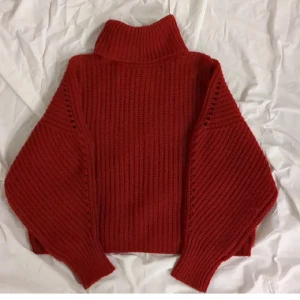 Röd stickad polotröja från Gant - Säljer en supermysig röd stickad polotröja från Carin Wester i storlek XS. Perfekt för kyliga höst- och vinterdagar. Tröjan har en hög krage och långa ärmar, vilket gör den extra varm och skön. Passar både till vardags och lite finare tillfällen. 🧣🍂