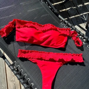 Röd bikini med volangdetaljer - Snygg röd bikini med volangdetaljer på både överdel och underdel. Från Nelly, använd fåtal gånger
