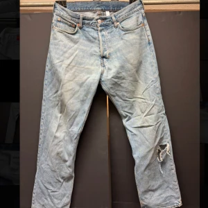 Blå Weekday ”space” jeans med slitning - Väldigt feta ljusblåa jeans från weekday. Jävligt feta med en liten slitning. Använt dem mycket men är i bra skick och efter en tvätt ser dem som nya ut! Skriv vid frågor✅