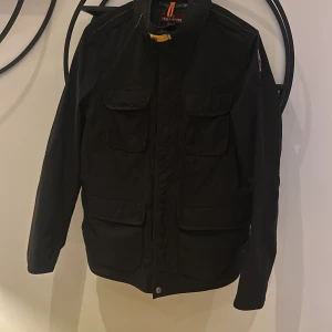 Parajumper jacka - Säljer denna svarta Parajumper jacka i modell desert spring, storlek M. Självfallet är jackan äkta och inköpt på NK, kvitto finns