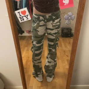 Bootcut camo cargos  - Lågmidjade bootcut cargobyxor med många fickor å detaljer🫶jag är 160cm fråga för mått:)
