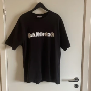 GOSHA  - The logo tee for SS18 is printed in cyrillic text with a metallic-bordered graffiti motif. The t-shirt is made from mid-weight jersey cotton, size up for a relaxed fit.
  Cond: 7/10