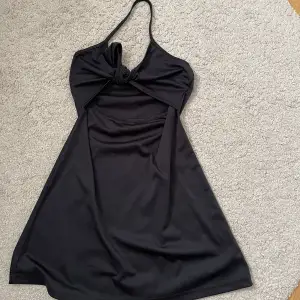 Svart klänning, som är öppen vid magen - Storlek 42 -  Köparen betalar för frakt - Inga returer - Betalning via köp direkt 