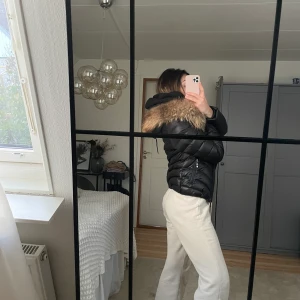 Jacka med pälskrage - Jättefin, varm jacka med pälskrage. Pälsen är äkta och väl omhändertagen och jackan lika så, därför ser den näst intill oanvänd ut. Insidan av jackans tyg var sönder när jag köpte den, men det har jag sytt så inget man lägger märke till. Liknar holliesjackorna.