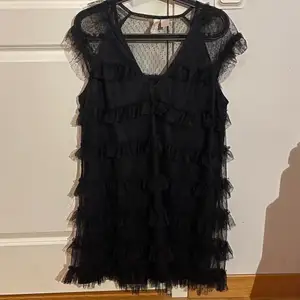 Jättefin svart prickig meshklänning med volanger. Klänningen är helt slutsåld! Använd en gång. Passar perfekt till fest! Kan passa mindre storlek. ⭐️BUDA⭐️ Säljer endast vid bra bud. 