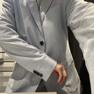 Kavaj - En kavaj från herr avdelningen på H&M. Aldrig använd och i fint skick! En jättefin babyblå färg som tyvvär inte visas på bilderna. Storlek L men som passar de flesta beroende på hur man vill att den ska sitta. 