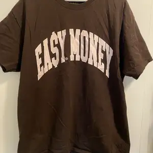 Brun T-shirt från märket easymoneyclo. Nästan helt oanvänd.