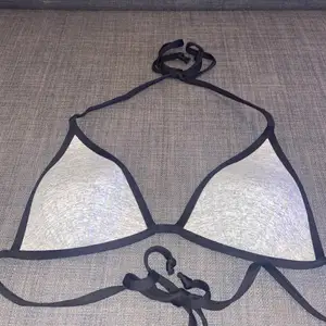  En grå bikini topp med knytning i nacke och rygg från H&M. Storlek XS. Är för liten på mig därav säljs den. 