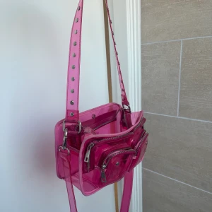Nunoo väska - Säljer min älskade nunoo väska i transparent rosa! Finns ej att köpa längre. Säljer då den tyvärr inte kommer till användning längre! 💕💕den är i väldigt fint skick och har kvitto kvar på den. 🙌🏼💖💗nypris ca 1200kr