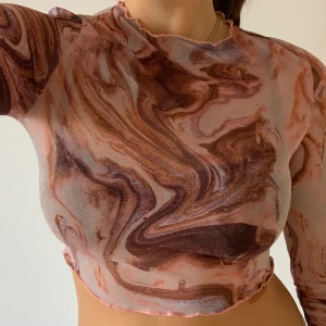 Meshtop - Supersnygg meshtopp i storlek S. Fint mönster i rosa färg. 