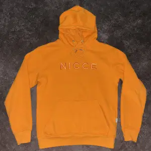 Orange hoodie från Nicce. 