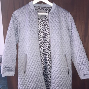 Grå kappa strl 146 - Ny kappa endast använd en gång storlek 146  Rak modell.  Leopardmönster inuti jackan 