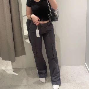 Grå lågmidjade cargobyxor - Säljer dess skitsnygga lågmidjade cargobyxor från Gina Tricot. Skitsnygga o använda en gång men säljer för insåg att de inte är min stil. Köpa för 499kr. Storlek 34. Passar 34/36 bäst💓💓💓 