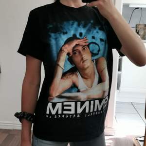 Cool T-shirt with printed graphic of the rap god ;) The print is black and white on the back side.