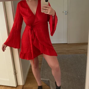 Röd klänning - Endast använd 1 gång. Röd klänning med vida ärmar och snörning i midjan från NA-KD. Bra skick. Storlek S, passar en S-M. 150kr + frakt, pris kan diskuteras❤️ BETALNING VIA SWISH SÅ EJ KÖP NU!!