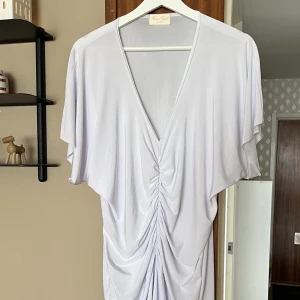 Klänning  - Vit klänning, lite genomskinlig så man får ha något under, funkar att dra upp till en topp också. Bra stretch.