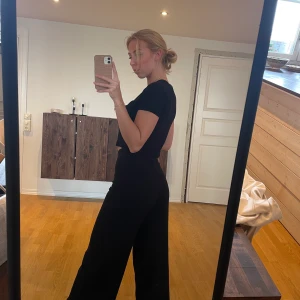 Vida byxor  - Ett par svarta vida kostymbyxor från weekday.  Höga i midjan  Dragkedja i sidan 