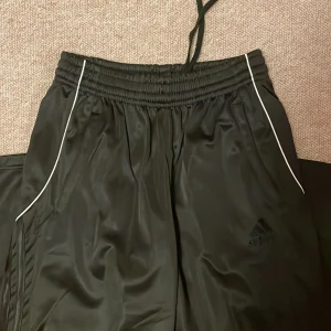 Adidas Trackpants - trendig trackpants. Jätte Y2k vibes! Det är kort på mig och jag är 169cm! tror jag att det är i barn storlek eftersom det är en gift. I dam storlek det är S
