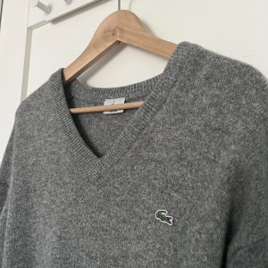 Lacoste - tröja - Grå, stickad tröja från Lacoste! Passformen är ganska oversized🤍