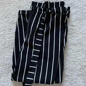 Paperbag pants Pull&Bear - Randiga byxor i paperbag modell från Pull & Bear. Storlek S. Fint skick för att ha använts mycket, endast några små trådar som gått på vissa ställen. Innerbenslängd: 55 cm. Midja: 32 cm. (mätt liggandes platt)