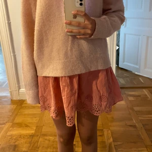 Rosa spetskjol - Säljer denna gulliga rosa spetskjol med ett vitt spets lager under som en super fin detalj! Kjolen har hålbroderier som föreställer blommor! Jag är en S och har den sittandes på höften lågmidjat! Hör av dig om fler bilder eller frågor💕💕