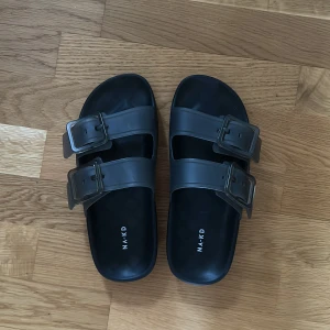 Tofflor  - Mörkgråa tofflor från NAKD i gummimaterial. Använda en gång!  Pris på hemsidan 349 kr, men storlek 37 är slutsålda.