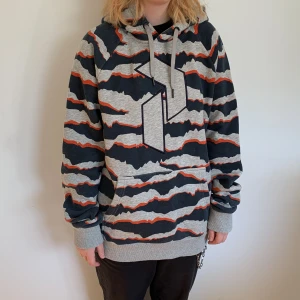 Peakperformance hoodie, Strl L, flerfärg - En grå/blå/orange hoodie, Peak Performance hoodie. Storlek L, passar oversized. Bra skick och skönt material!