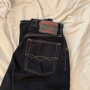 Svarta jeans - Coola svarta raka jeans med vita sömmar. Tyvärr så är dragkedjan sönder dock🎸 Storlek: W:27, L:32