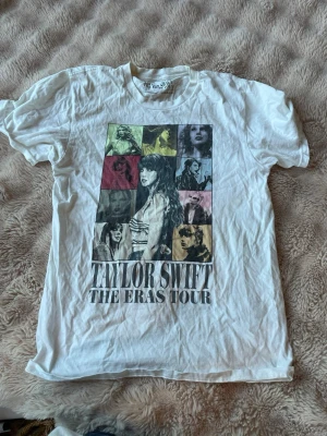 Taylor Swift The Eras Tour t-shirt - Vit t-shirt med färgglatt tryck av Taylor Swift och olika bilder från The Eras Tour på framsidan. Den är köpt på Eras tour år 2024 och är i väldigt bra skick!!