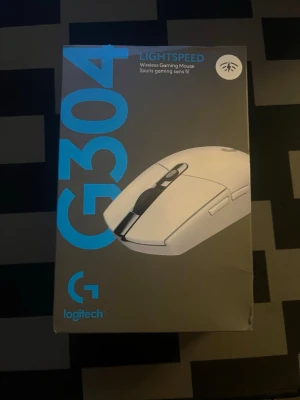 Vit Logitech G304 trådlös gamingmus - Säljer en vit Logitech G304 LIGHTSPEED trådlös gamingmus. Musen har en stilren design med flera knappar och scrollhjul, perfekt för gaming eller vardagsbruk. Ergonomisk form och lätt att ta med sig. Levereras i originalförpackning.