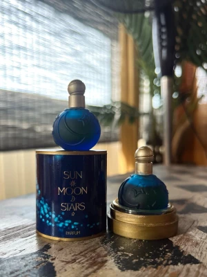 Karl Lagerfeld Sun Moon Stars Parfum 2x3,7ml vintage/rare/ discontinued  - Unik parfym i en rund, djupblå glasflaska med guldfärgad kork. Flaskan har stjärn- och månrelief och kommer i en matchande blå och guld kartong med texten 'Sun Moon Stars'. Perfekt för dig som gillar snygg design och mystiska dofter.
