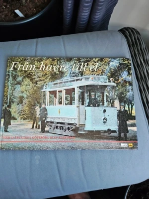 Från havre till el - Boken 'Från havre till el' handlar om när spårvägen i Göteborg blev elektrisk för 100 år sedan. Omslaget visar en gammal spårvagn i ljusblått och svartvitt foto. Perfekt för dig som gillar historia och Göteborgs lokaltrafik.