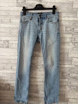 Meuw Stockholm  - Ljusblåa jeans från meuw stockholm, nypris ca 1800kr. Fit: Lou straight  En defekt längst ner på ena benet