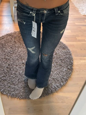 Low Rise Flare jeans - Lågmidjade mörkblå flare jeans med vita detaljer på bakfickorna köpta från Gina Tricot. Jeansen är aldrig använda och har även prislappen kvar 💗